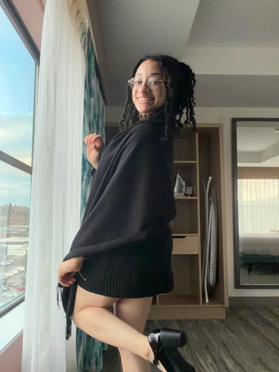 Ella smiling beside a sunny window